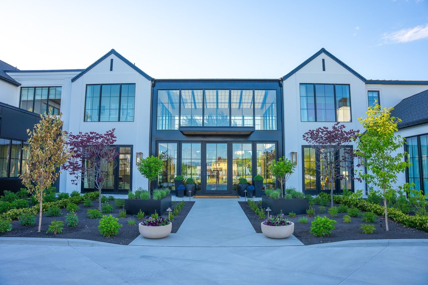 Planted entry beds with ornamental trees, path lighting and containers at a Northern Utah residence